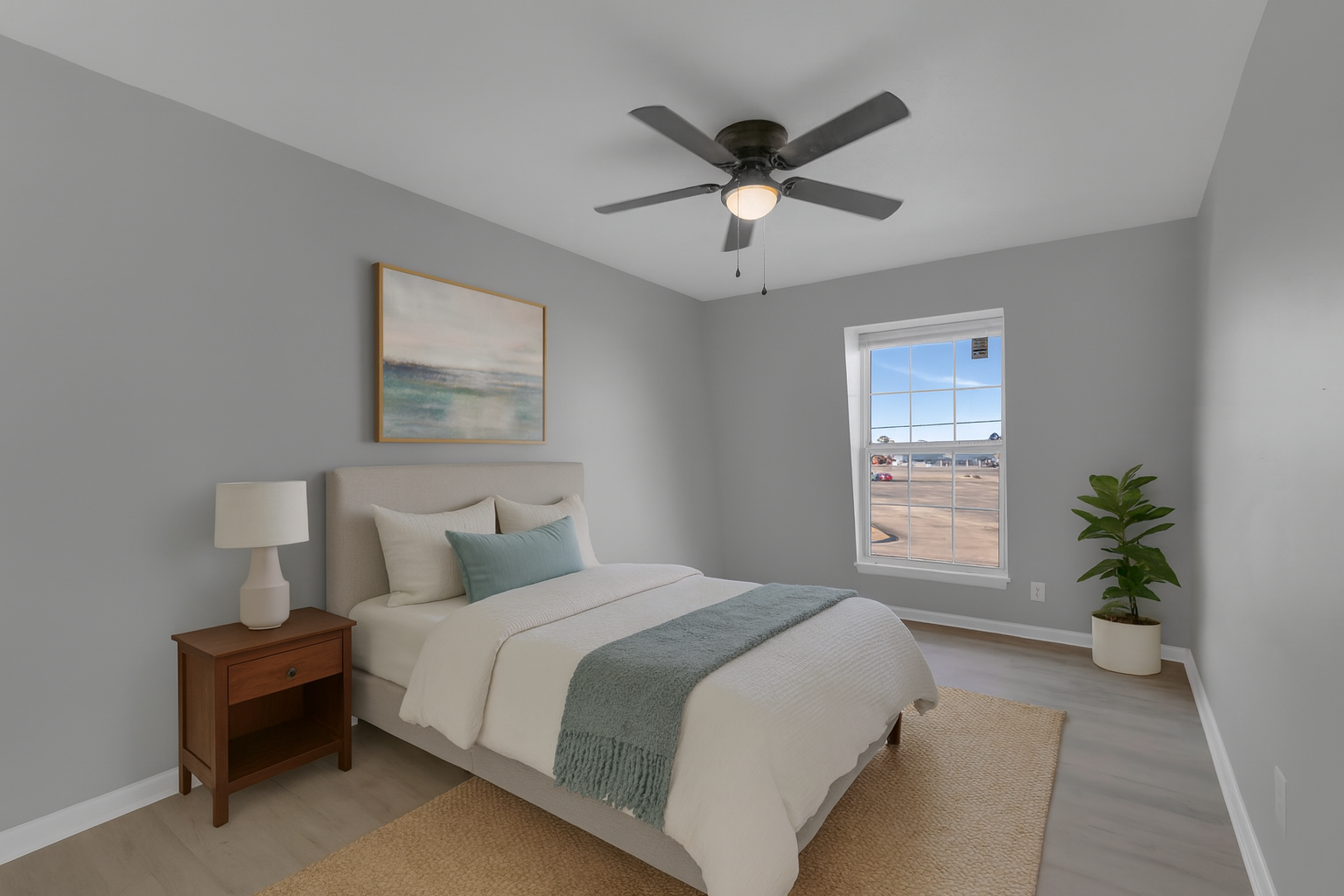 Dining room with round table and four chairs. Wall art and hallway visible.