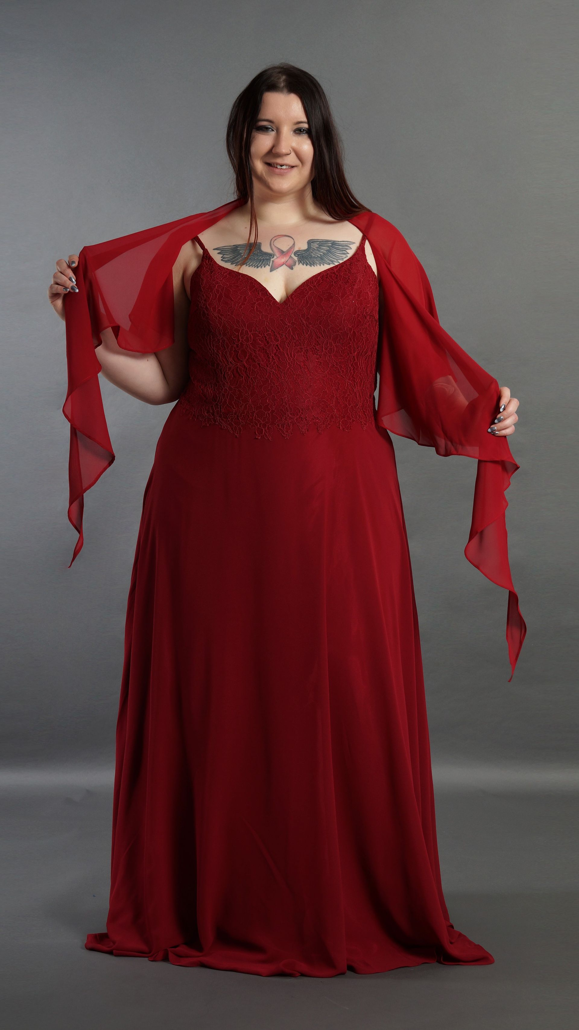 Eine Frau trägt ein rotes Kleid und einen roten Schal.