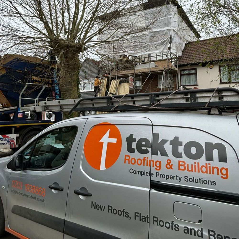 A tekton roofing and building van is parked in front of a house.