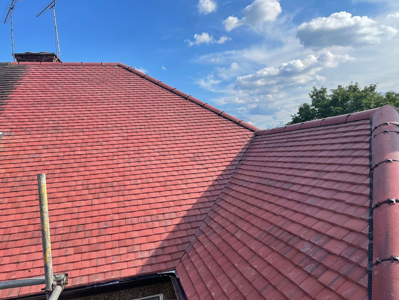 A red tiled roof with a blue sky in the background.