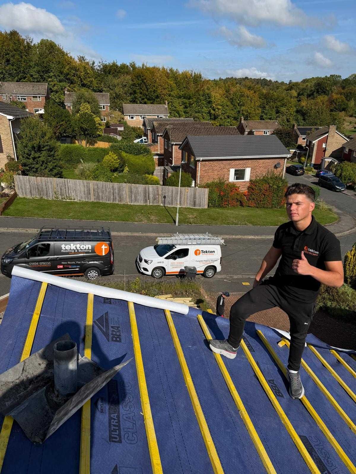 A man is standing on the roof of a building.