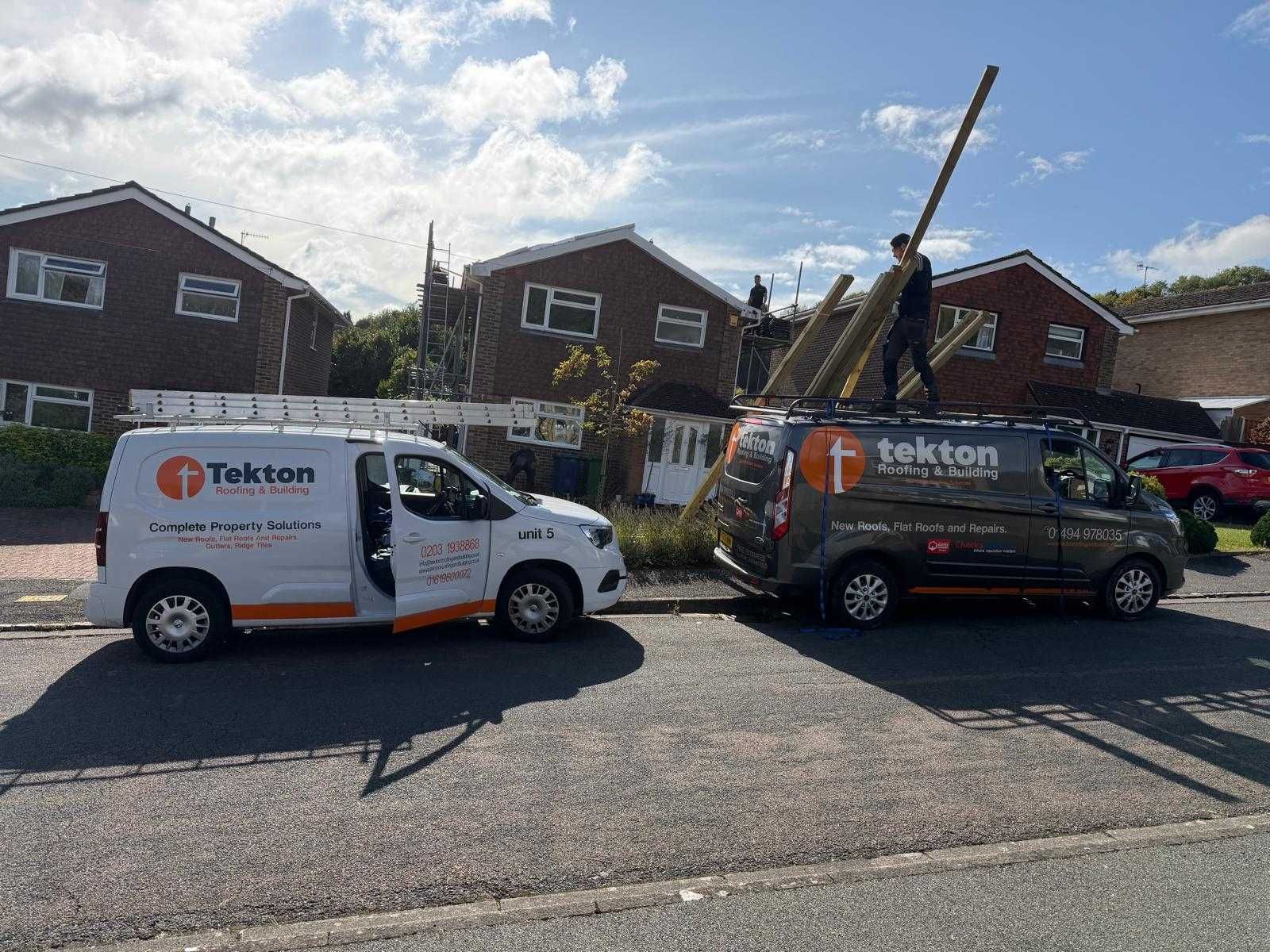 A tekton roofing and building service van is parked in front of a house.