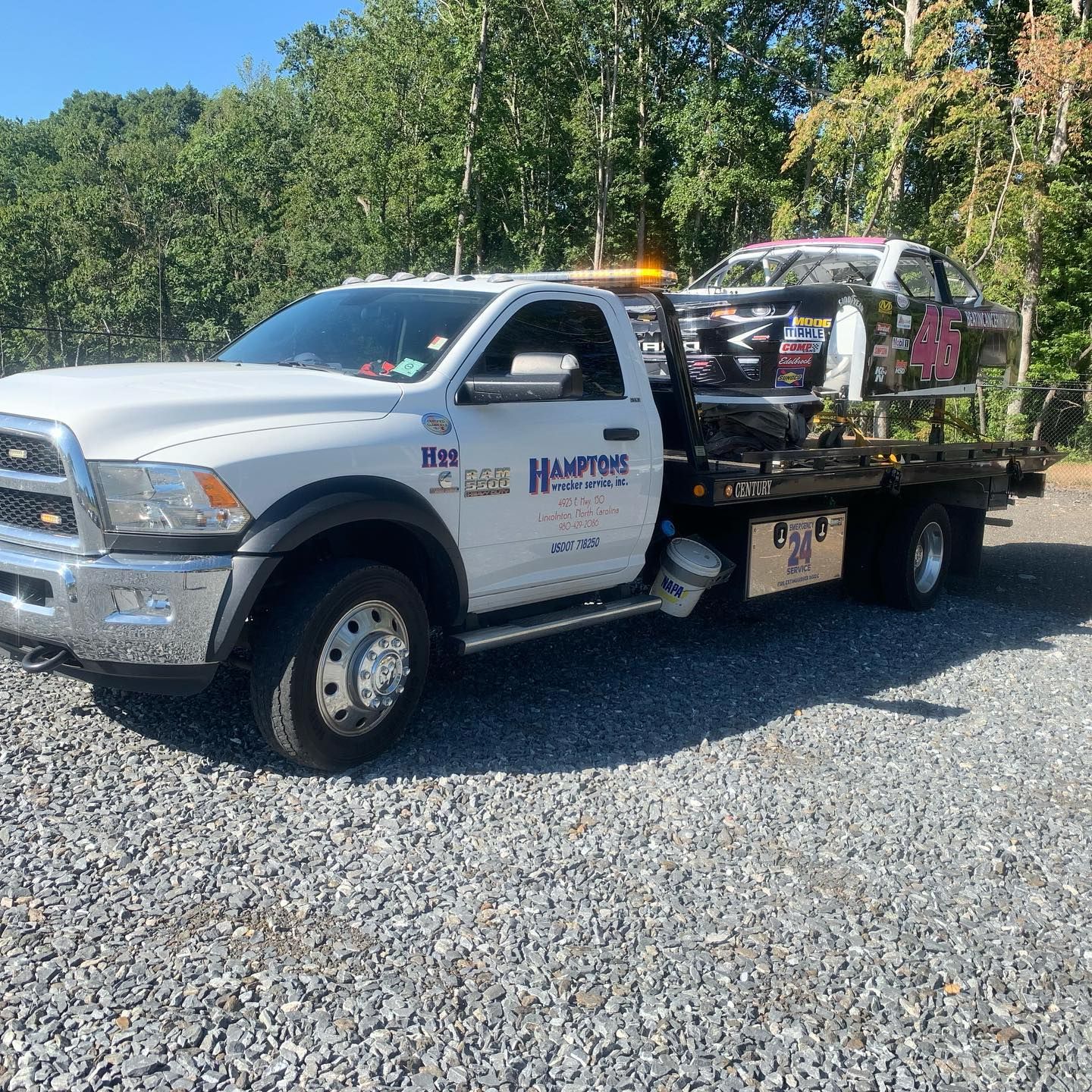 White tow truck with the words 