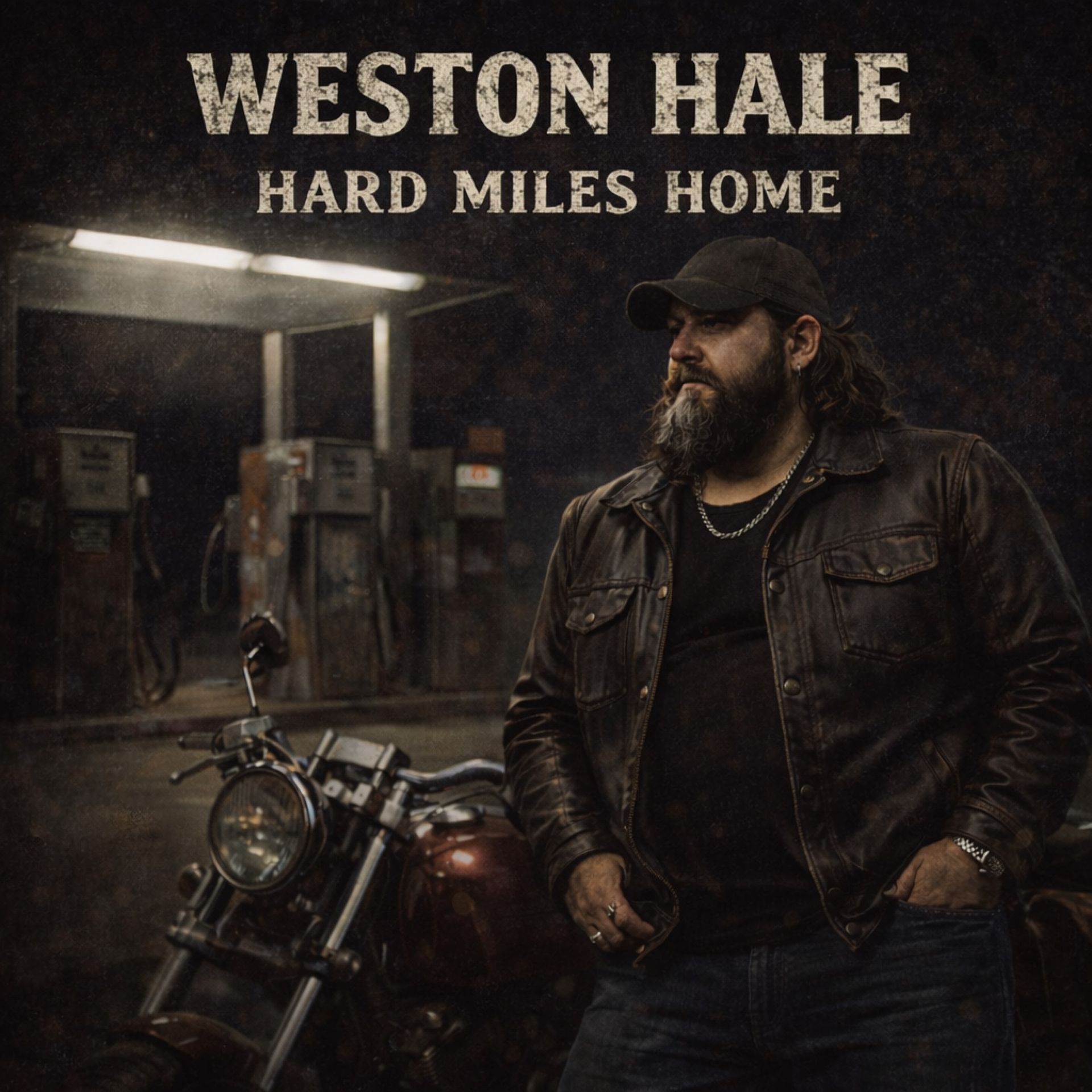 A man in a leather jacket and cap stands beside a motorcycle at a dark gas station. Text above reads 