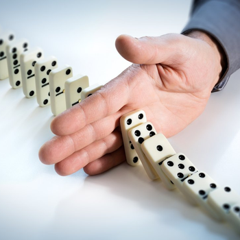 Hand stopping a domino effect