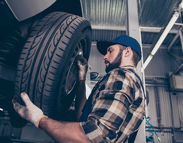 Auto Detailing — Technician Changes Tires in Harrisburg, PA