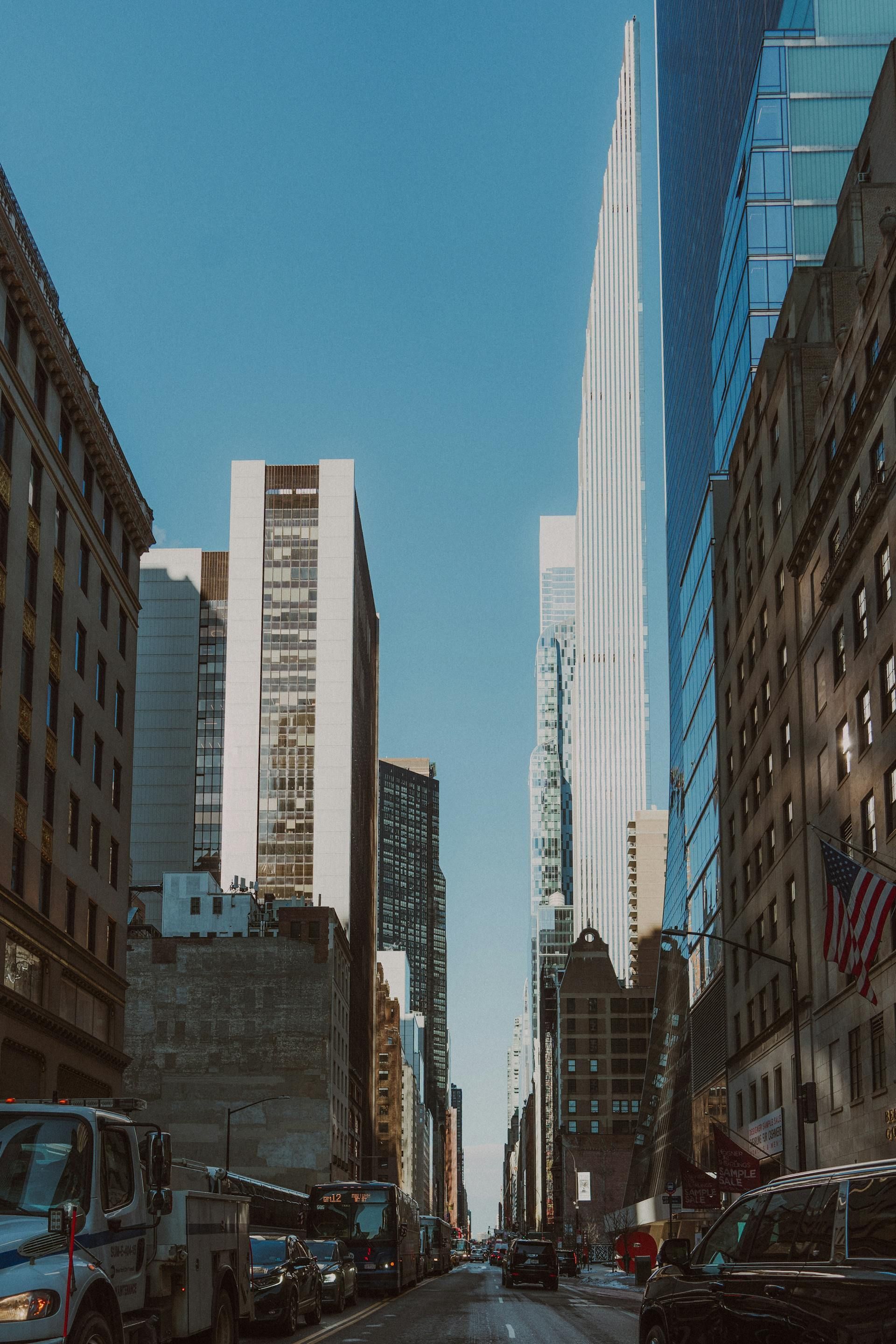 Palm tree on white sandy beach, turquoise water, blue sky.