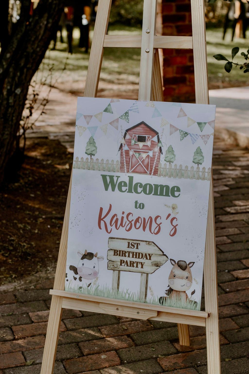 A wooden easel with a welcome sign on it.