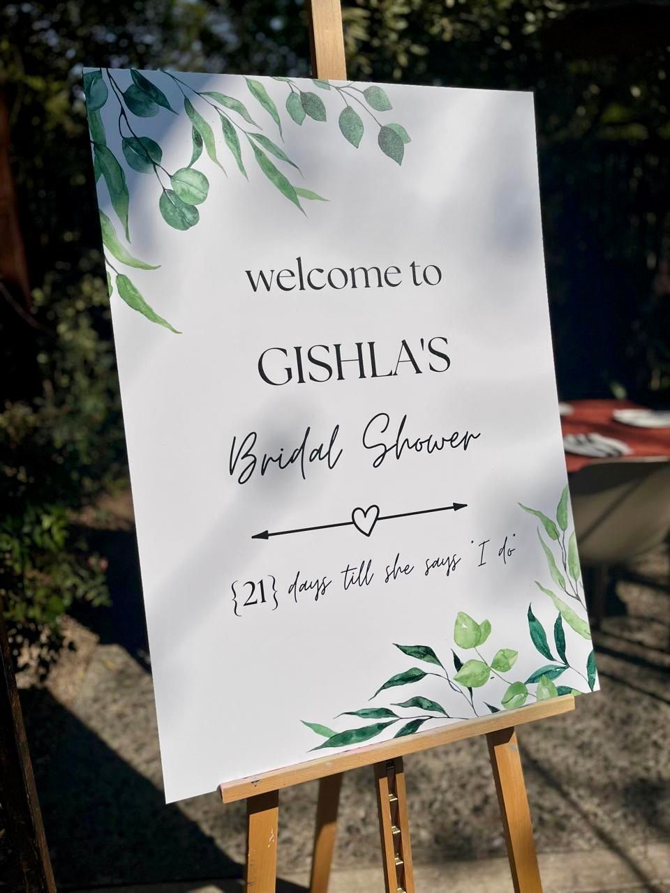 A welcome sign for a bridal shower is sitting on an easel.
