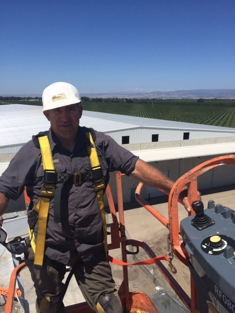 Worker installing chimney on roof top — Los Molinos, CA — North Valley Cleaning