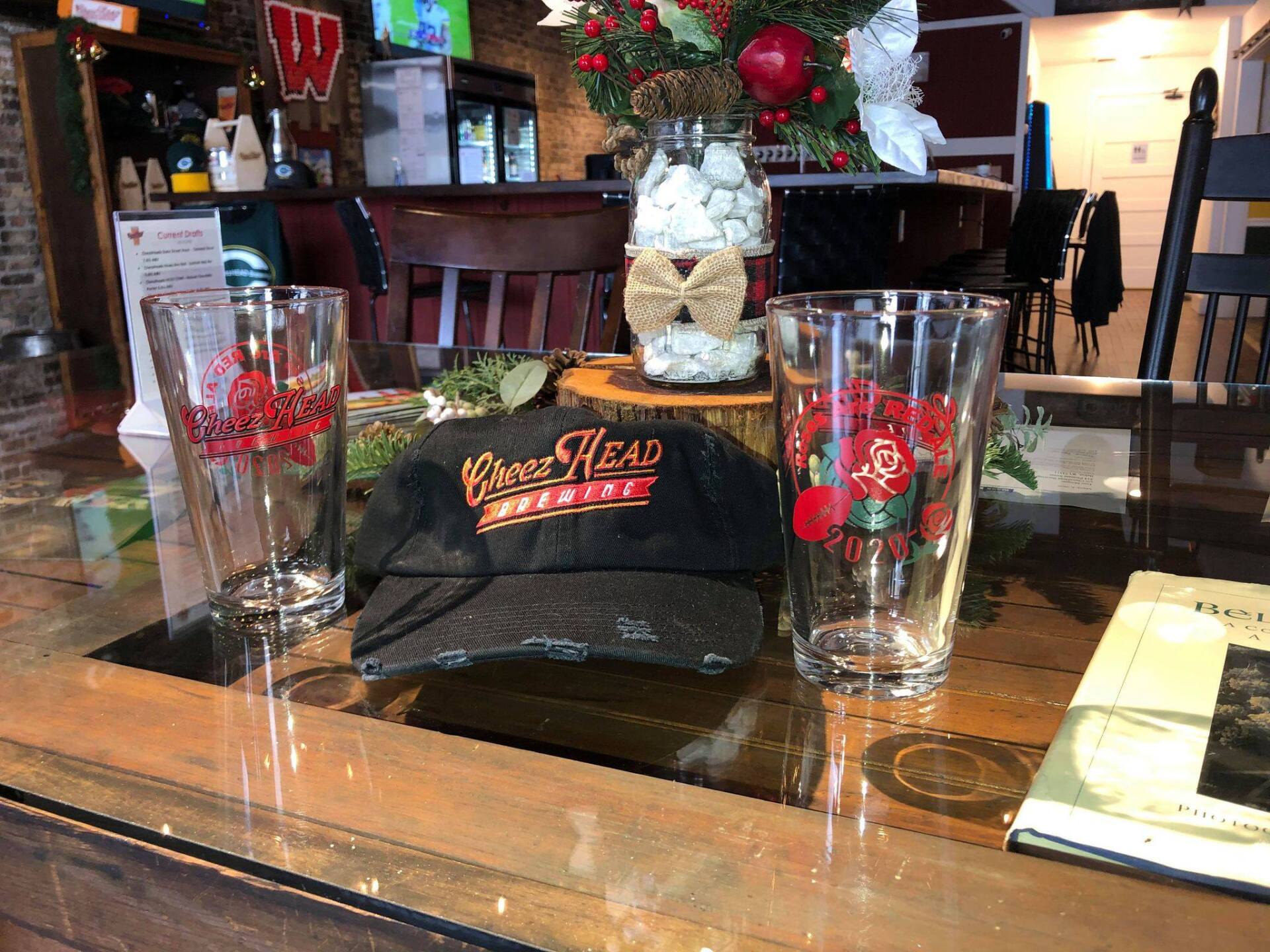 Beer Glasses with Hat on Table - Beloit, WI - CheezHEAD Brewing