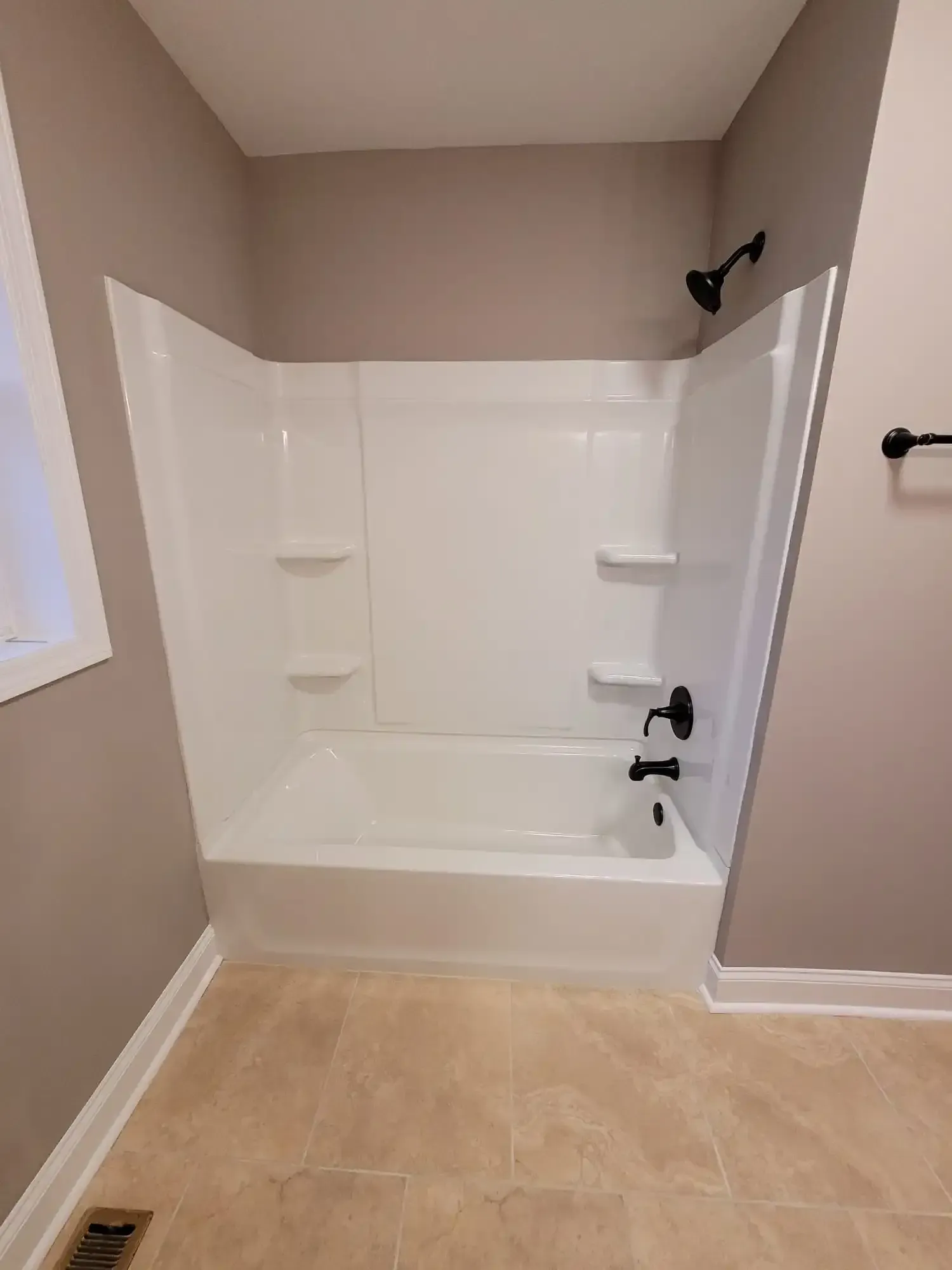 A bathroom with a bathtub and a shower stall.