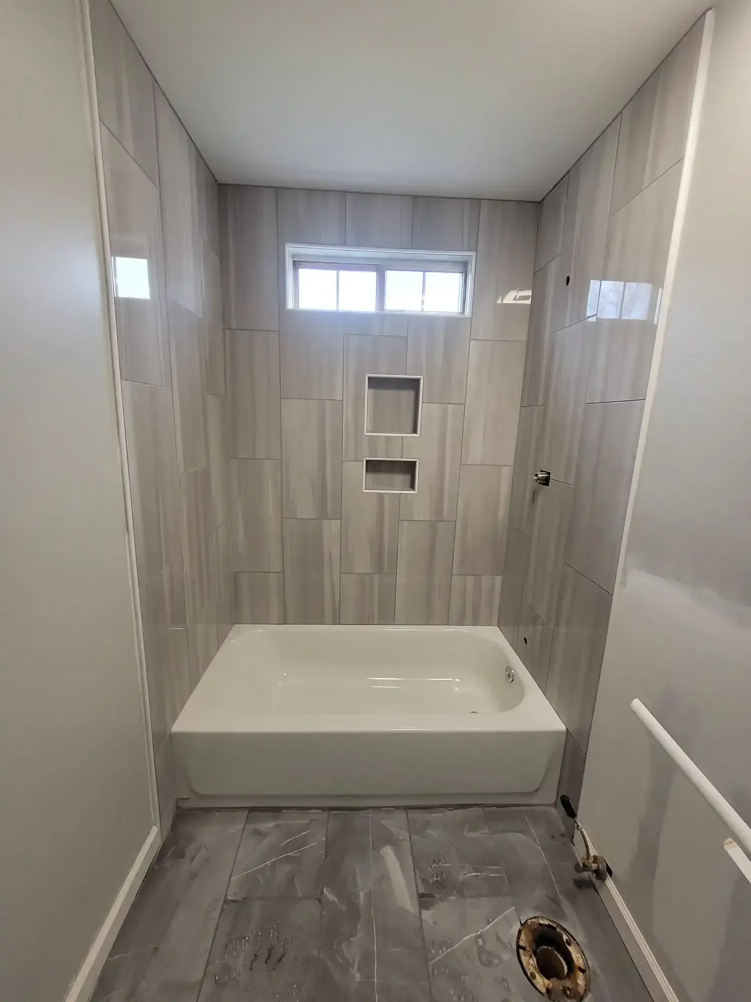 A bathroom with a bathtub and a shower.