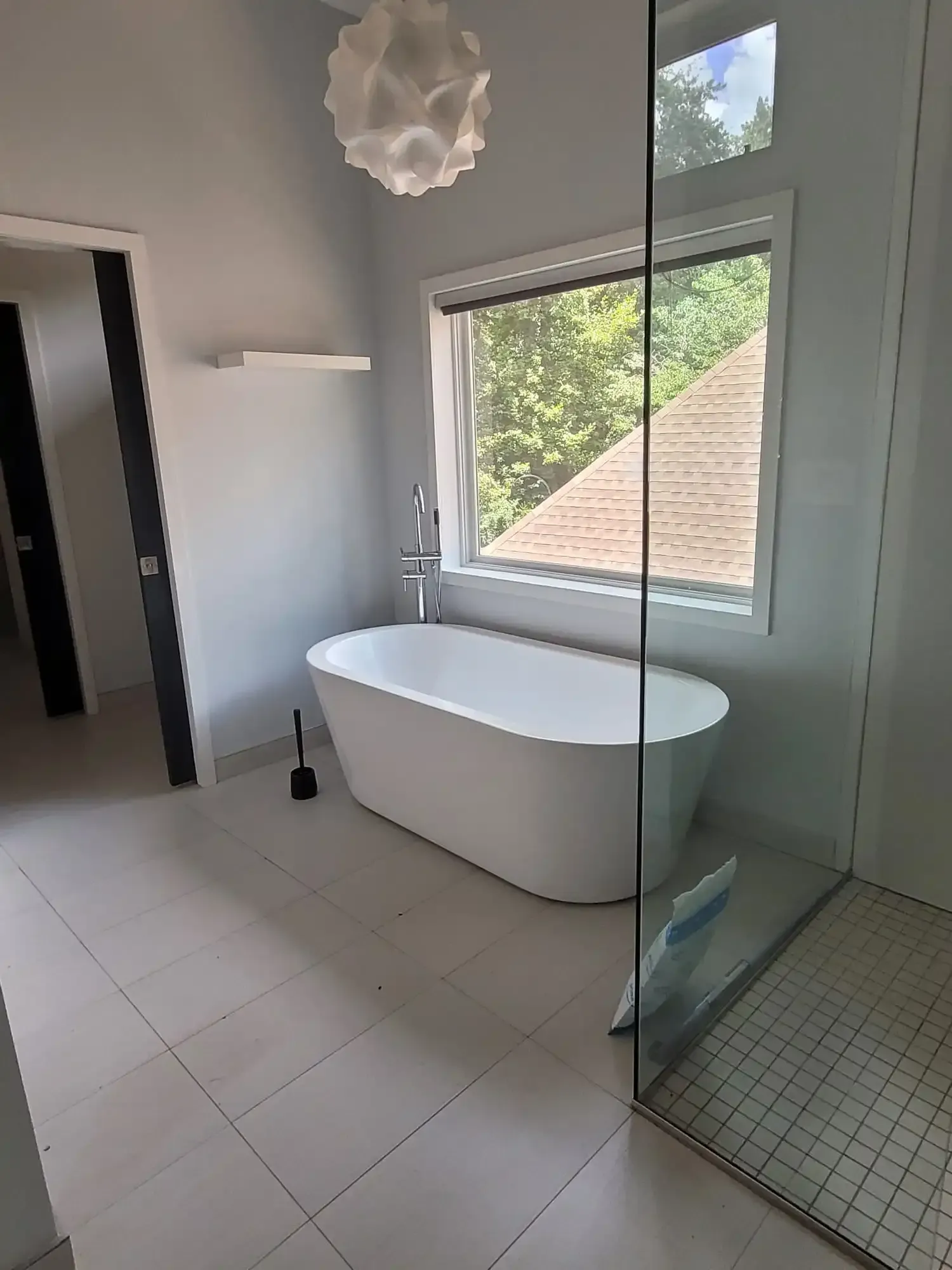 A bathroom with a bathtub and a walk in shower.