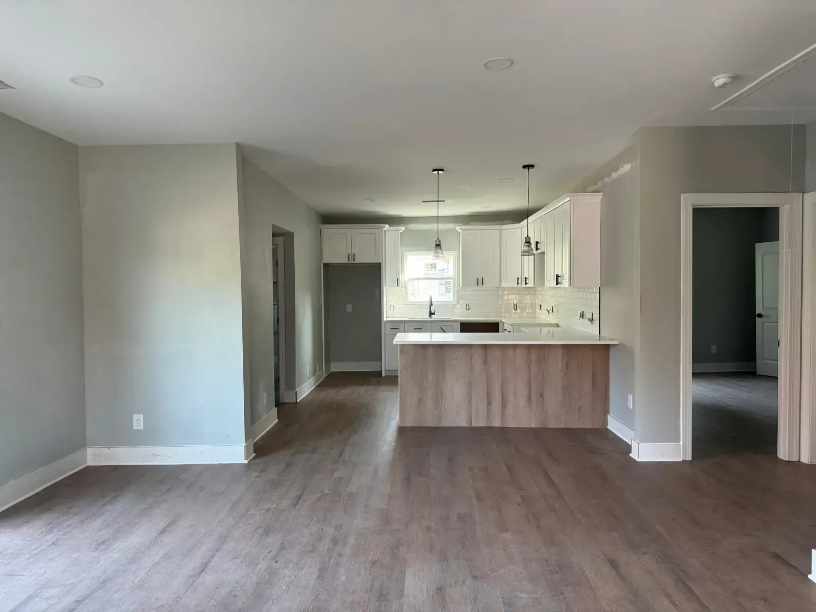 An empty house with a kitchen and a living room