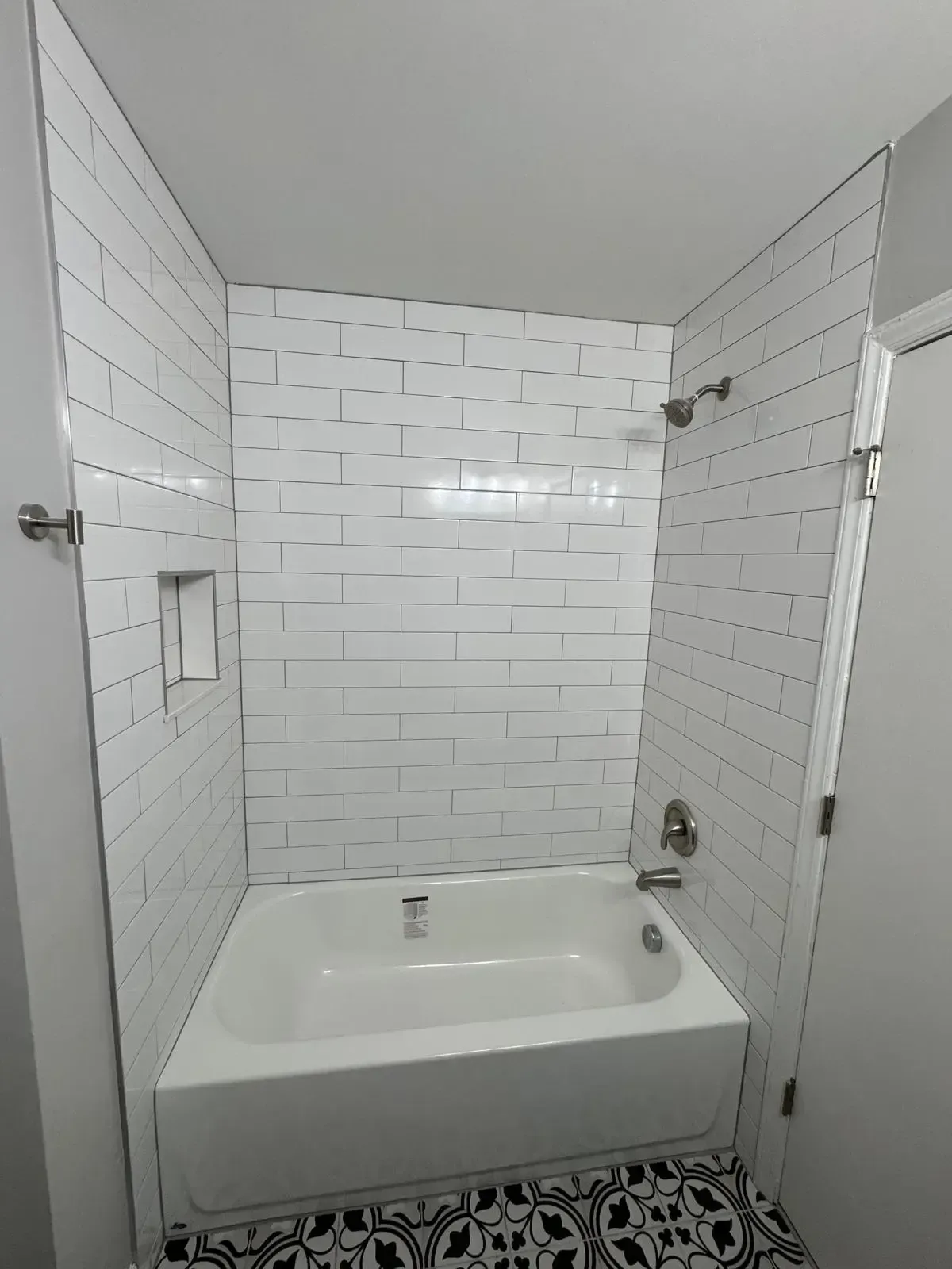 A bathroom with a bathtub and a shower.