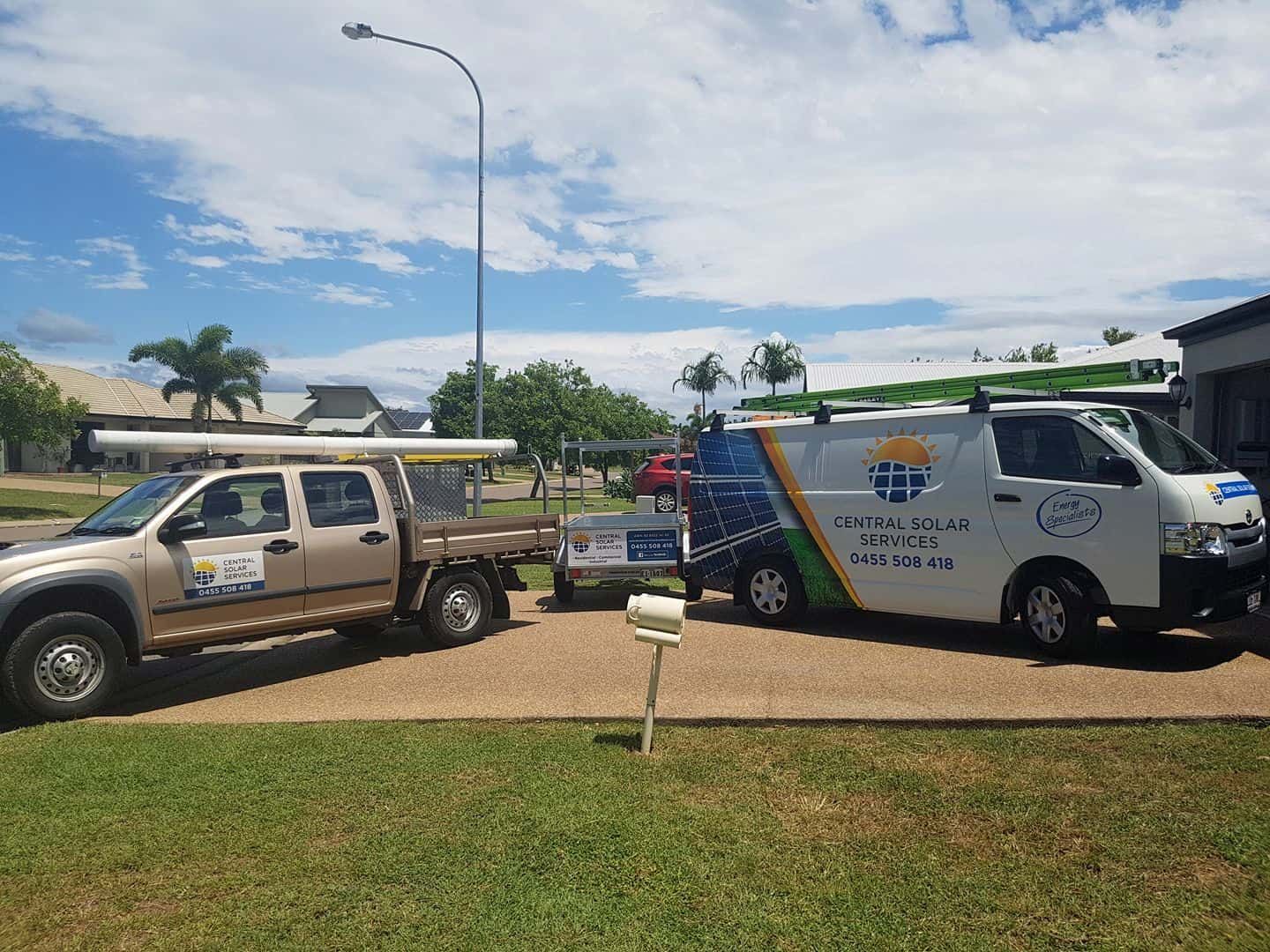 Two Trucks and A Van Are Parked in Front of A House — Central Solar Services in Garbutt, QLD