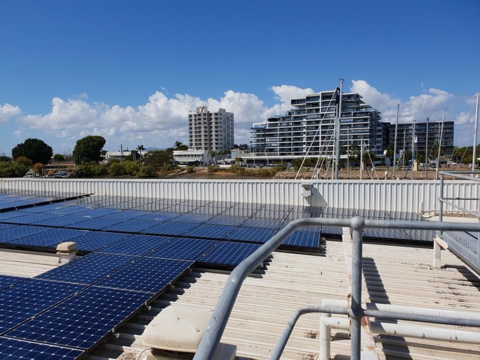 There Are Many Solar Panels on The Roof of A Building — Central Solar Services in Garbutt, QLD