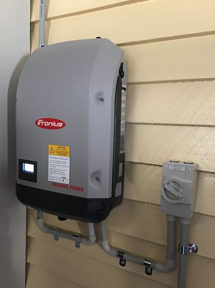 A Fronius Inverter Is Mounted on The Side of A House — Central Solar Services in Garbutt, QLD
