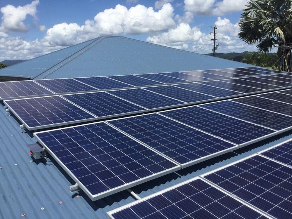 solar panels installed on metal roof under sunny sky in Townsville