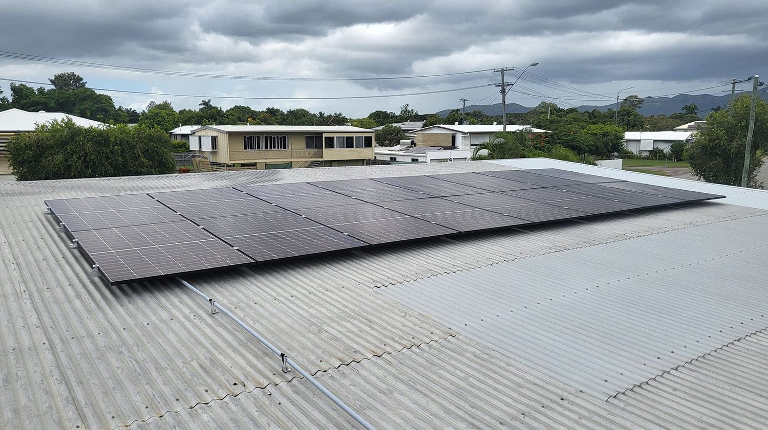 A Rectangular Array Of Solar Panels Mounted On A Corrugated Metal Roof