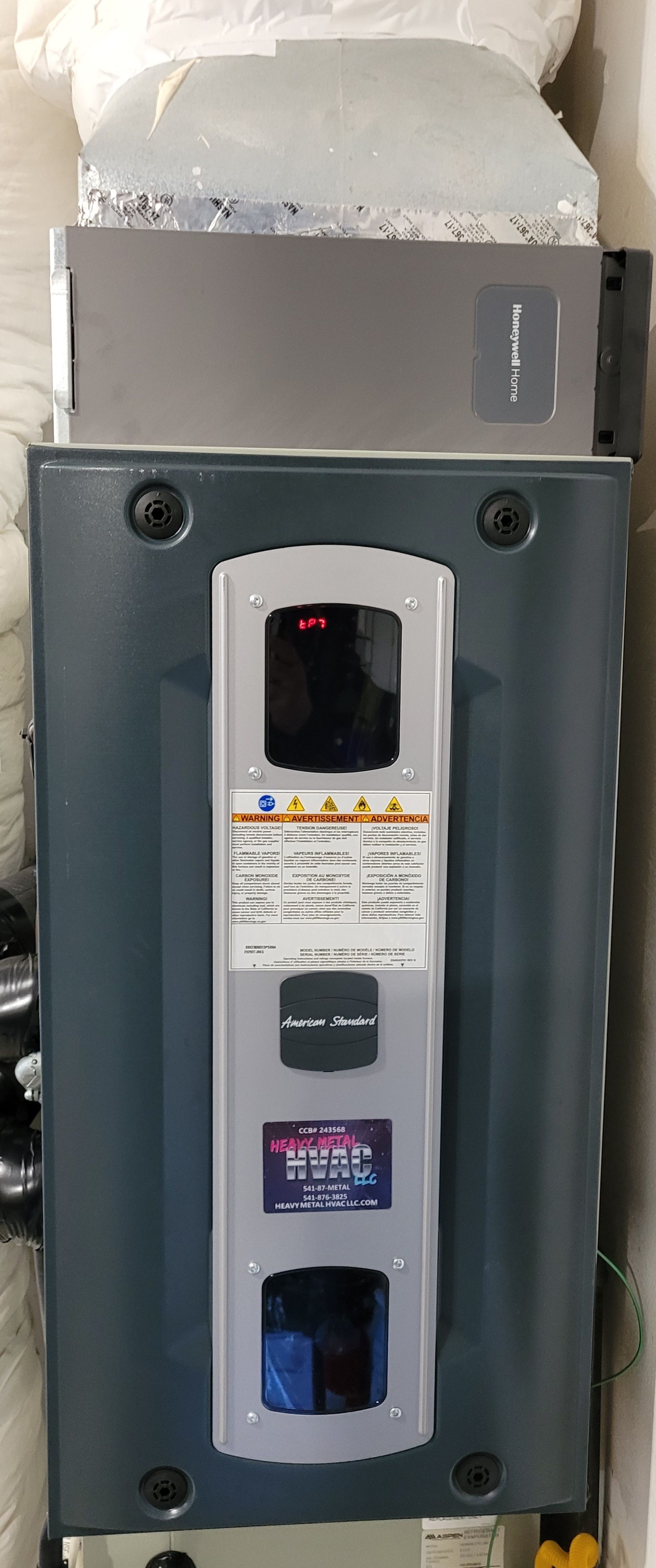 Heavy Metal HVAC LLC - An HVAC system control panel. A red light glows on the display.