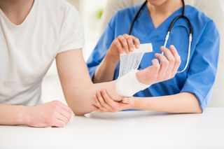 Physical Therapy Appointment — Doctor Bandaging Hand of Male Patient in Natick, MA