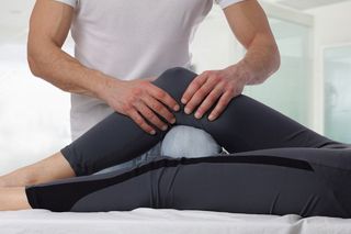 Auto Injury Physical Therapy — Therapist Doing Healing Treatment on Women's Leg in Natick, MA