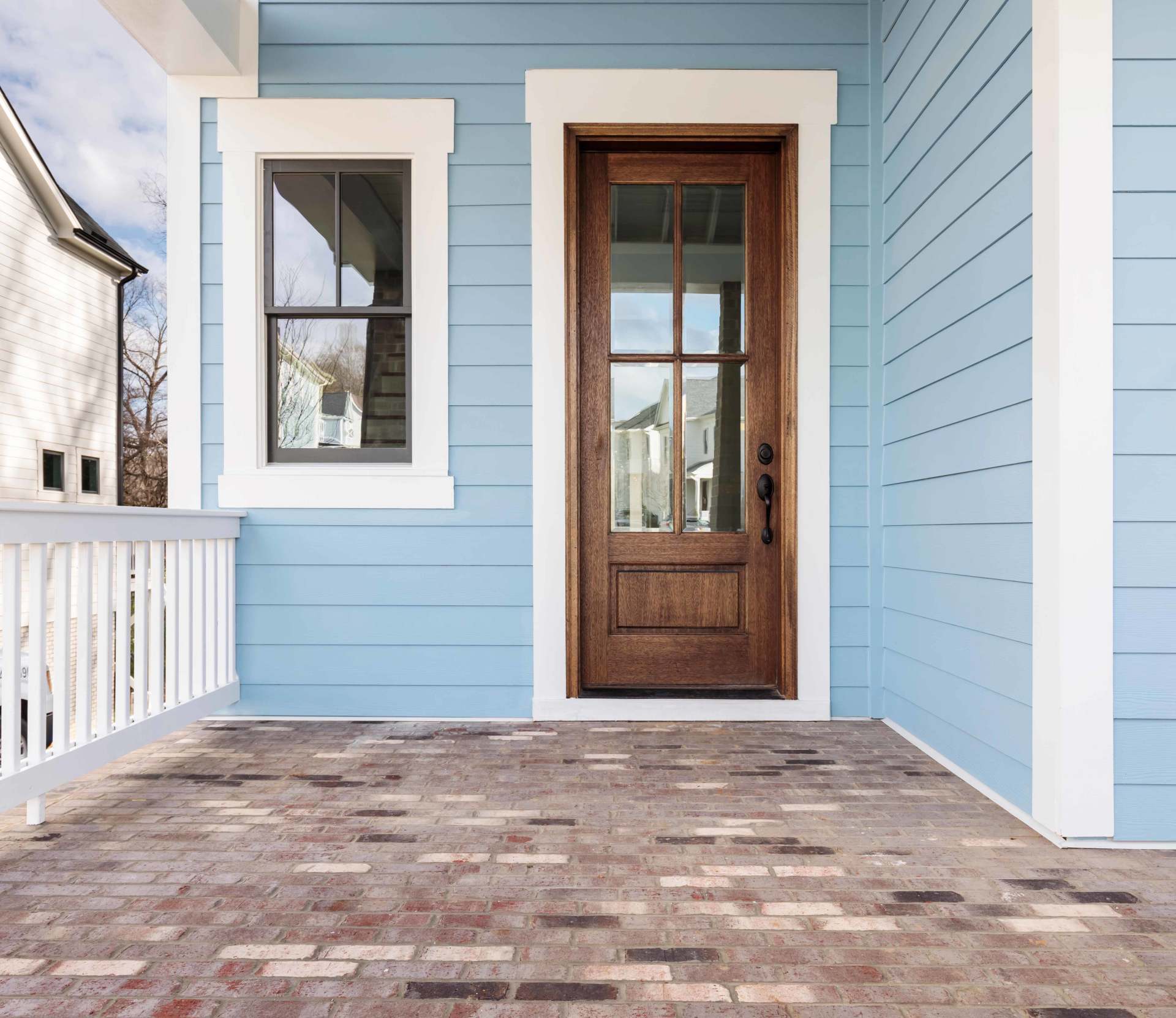 A Blue House with Wood Door — Detroit, MI — Protector Window & Door
