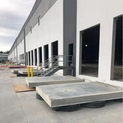 a machine is sitting in front of a building that says for rent