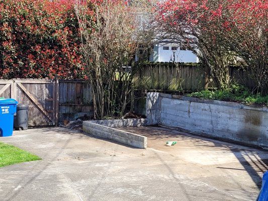 a blue trash can with the number 18 on it is in a backyard .