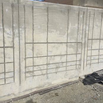 a concrete wall with a grid pattern on it is being built .