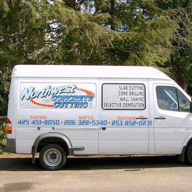 a northwest concrete cutting van is parked in a parking lot