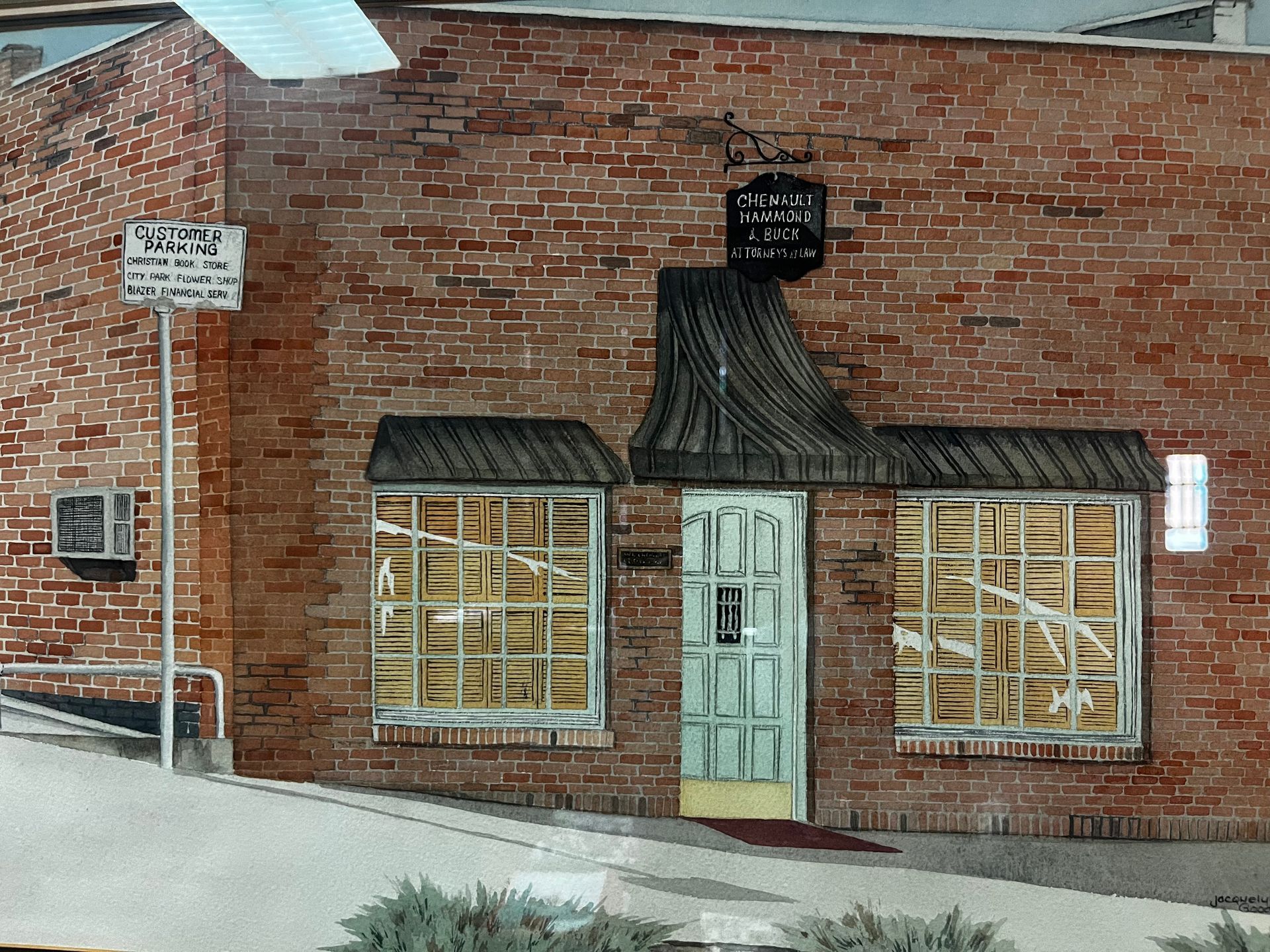 A brick building with a sign that says parking
