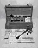 A black and white photo of a briefcase filled with various objects.