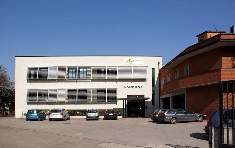 A large white building with cars parked in front of it