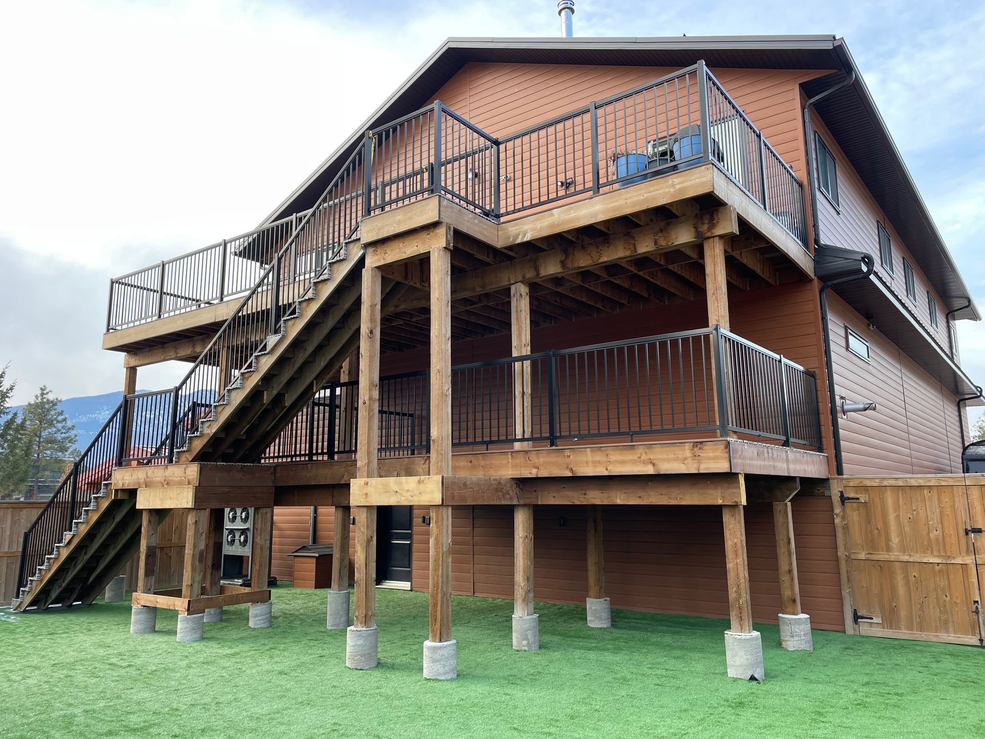 multi layered deck with stairs from top floor of house down