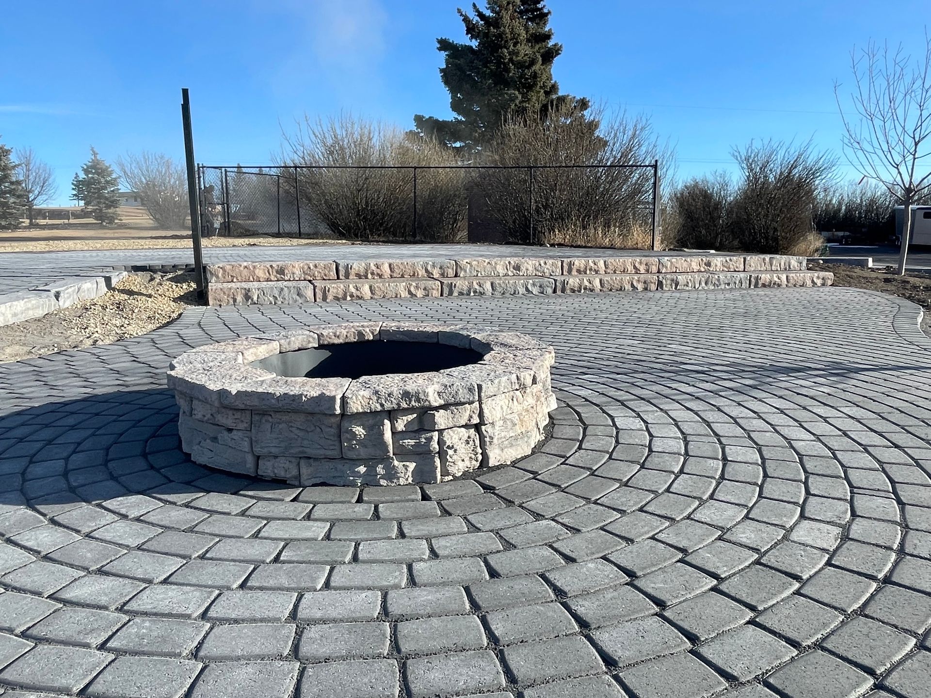 circular stone patio and built in stone fire pit