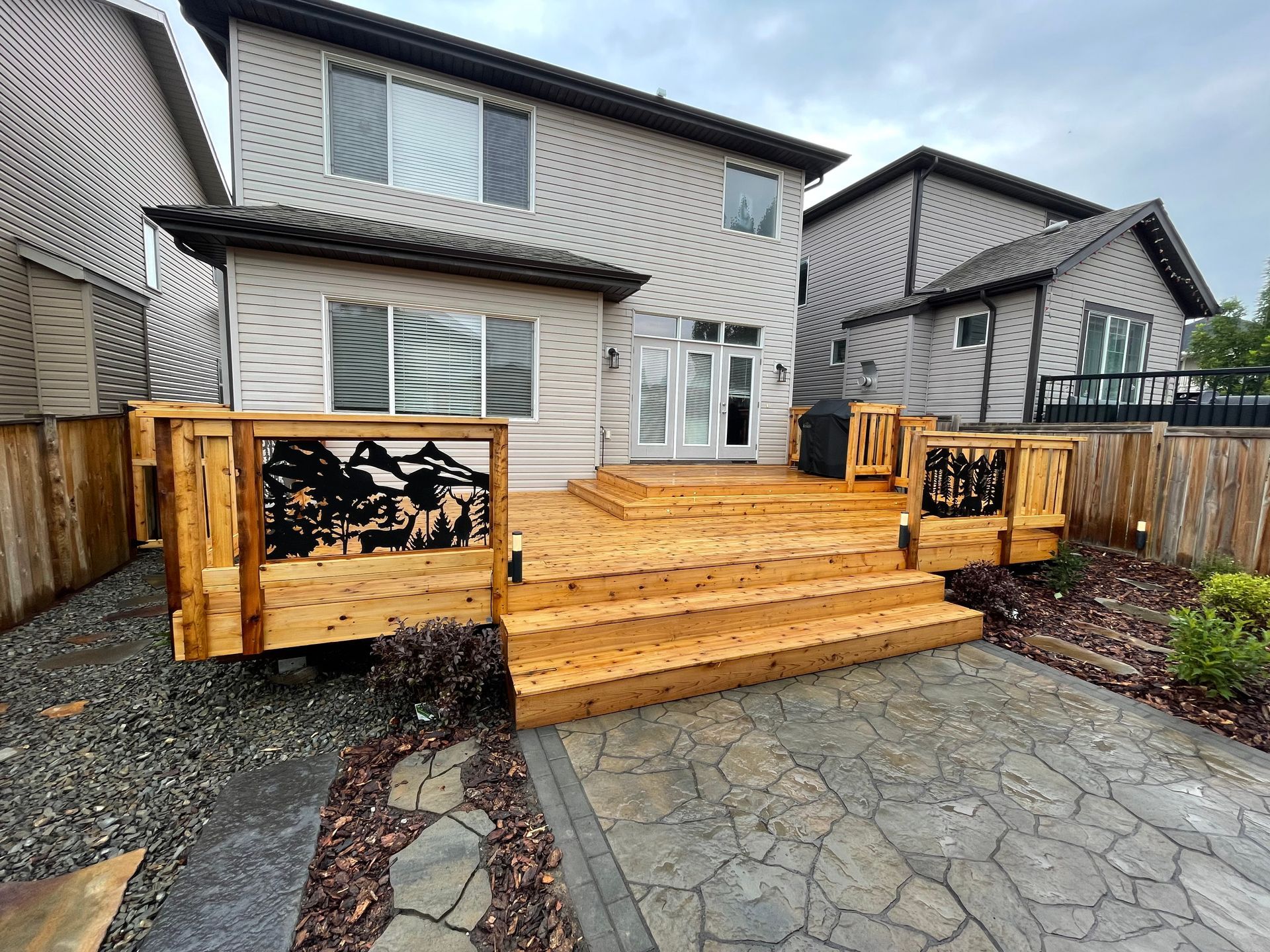 metal design built into deck and stairs down to stone pathway