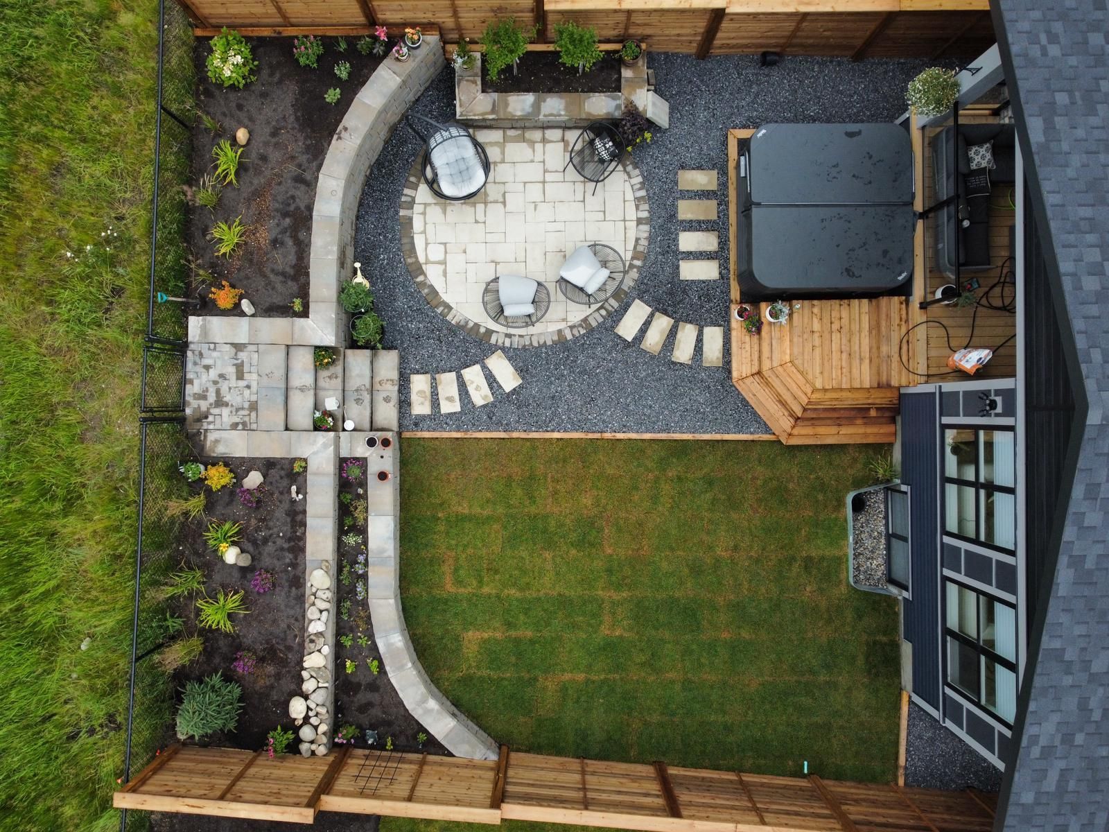 aerial view of a whole landscape design with deck, patio and tiered gardens