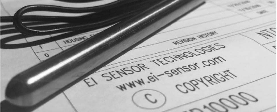 A pen is laying on top of a piece of paper that says ei sensor technologies