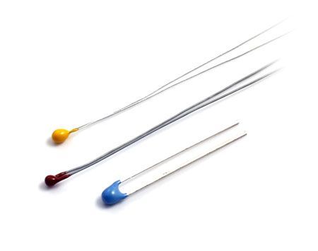 A group of three different colored electronic components on a white surface.