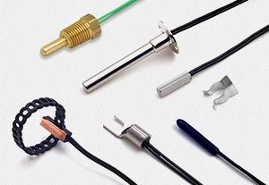 There are many different types of thermometers on a white surface.