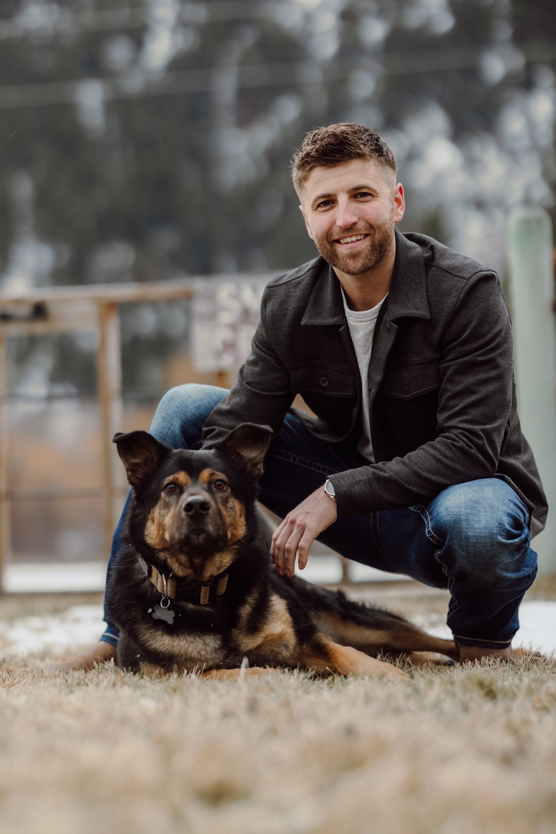 Backyard deck with latticework railing next to a sunroom attached to a two-story house.