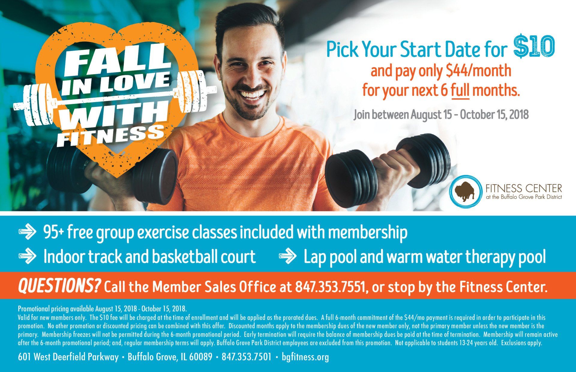 A man is holding dumbbells in front of a sign that says fall in love with fitness