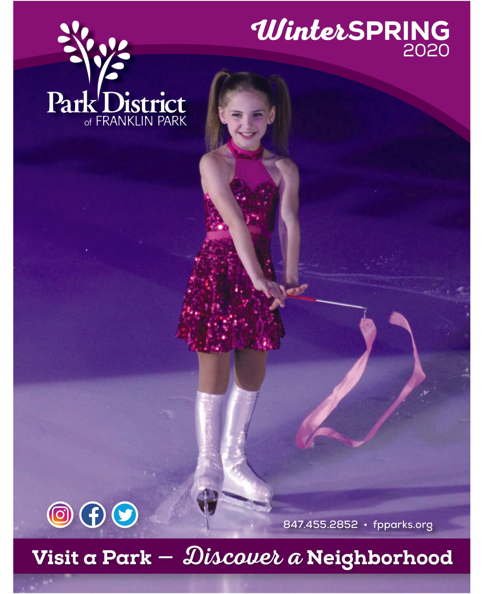 A girl in a pink dress is holding a pink ribbon while ice skating