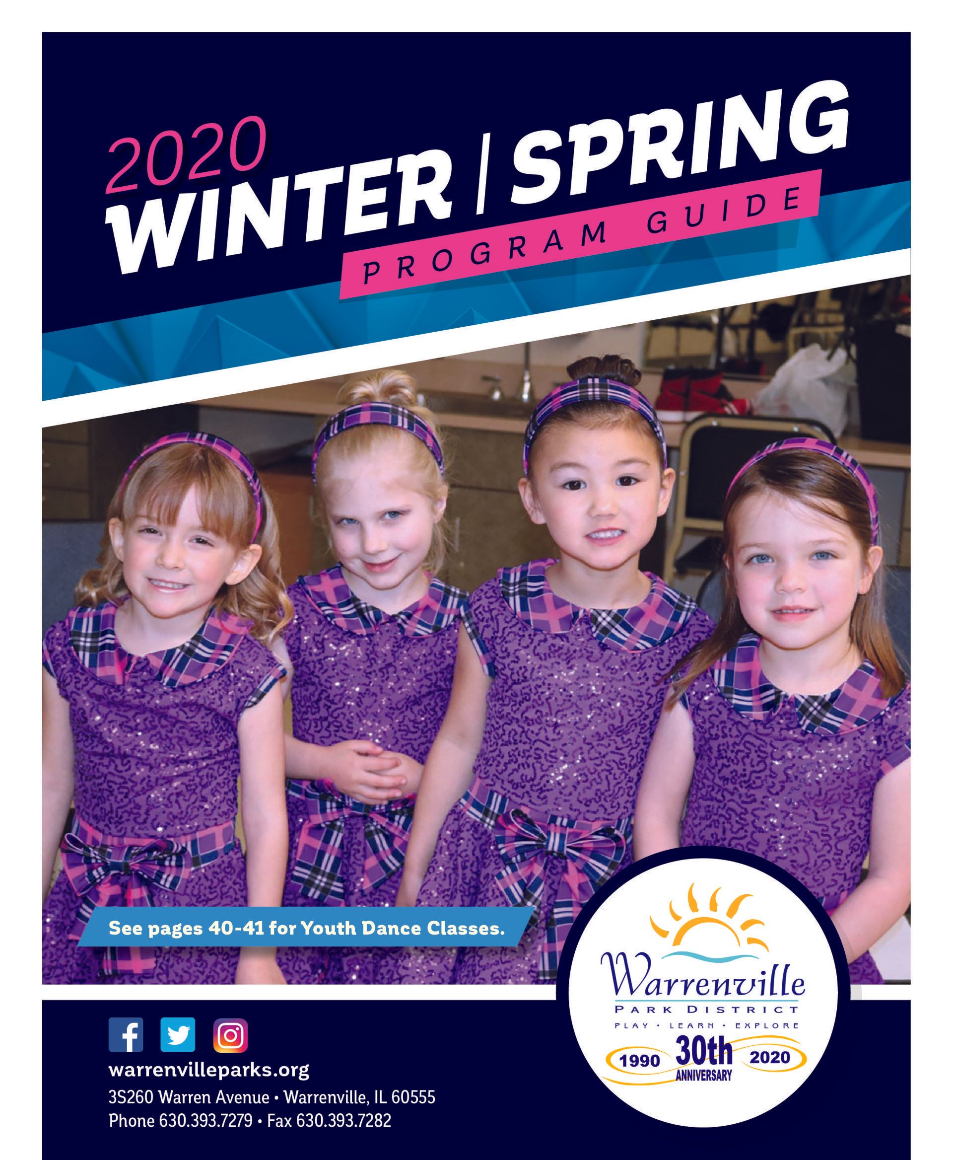 A group of young girls are standing next to each other in purple dresses.