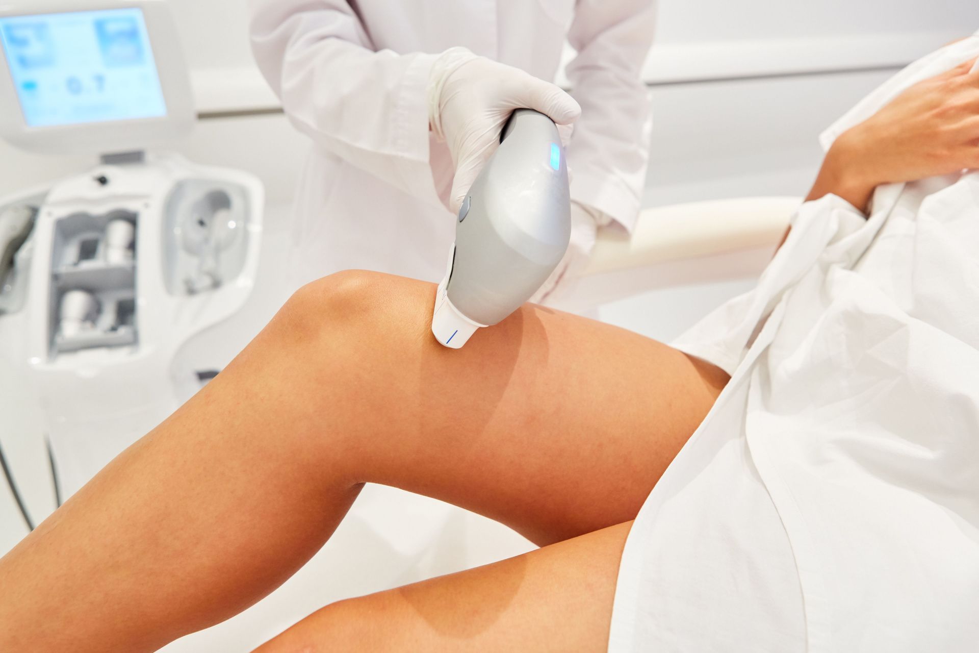 a woman is getting a laser hair removal treatment on her leg .