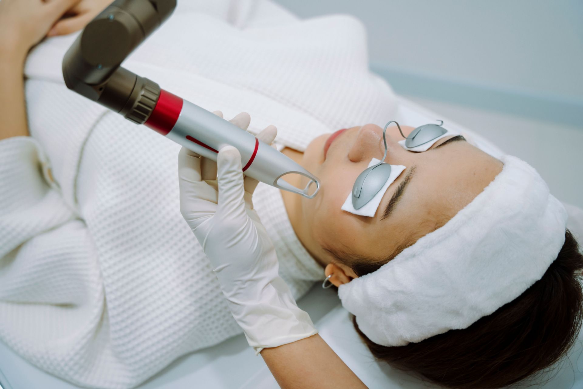 a woman is getting a laser treatment on her face .