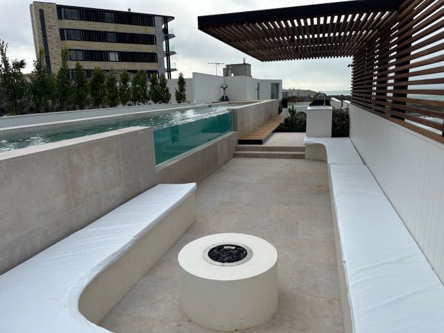 A patio with a fire pit and a swimming pool